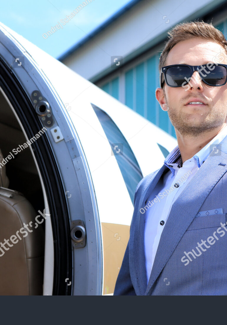 stock-photo-young-passenger-wearing-sunglasses-by-the-entry-door-of-the-executive-jet-436558939